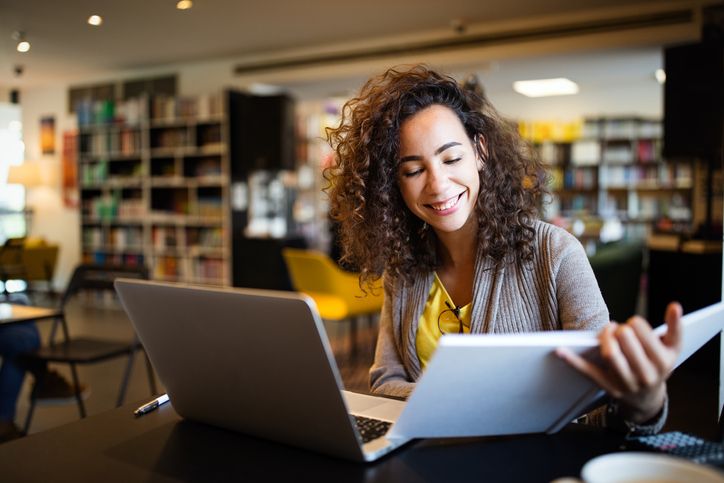 Smiling healthcare college student completing focused studying session in a quiet space