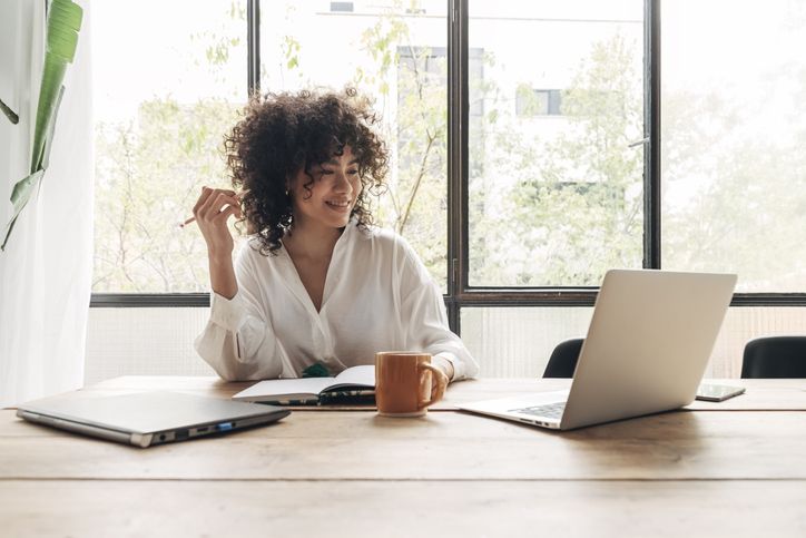 Young professional completing a hybrid class online for a remote session