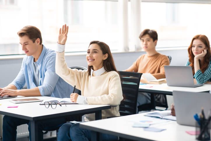 A student pursuing a medical office assistant career raises her hand asking for help