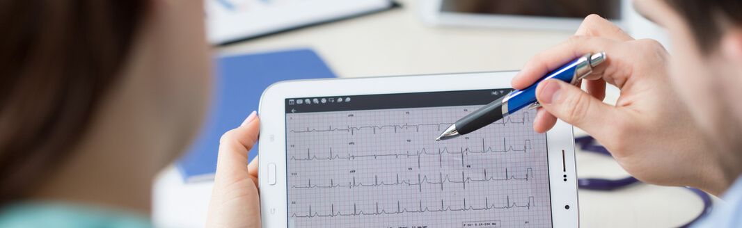 A female EKG technician working in a hospital after medical office specialist training